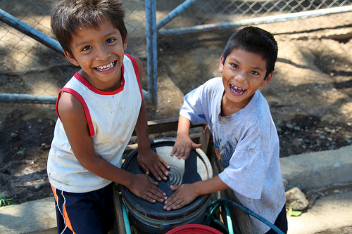 Orlando Javier & Wilder José fetching water with a little pull cart.  Visiting the World Bank funded water project in a barrio (neighbourhood) in Managua, the capital of Nicaragua.